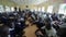 KENYA, KISUMU, 15.05.2018. Big group of bald african kids and teenagers sitting and listening to caucasian volunteers.