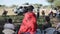 KENYA, KISUMU - MAY 20, 2017:Back view of bald African woman in red long cape from local tribe maasai.