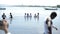 KENYA, KISUMU - MAY 20, 2017: Caucasian people baptize African people in white clothes in the water on shore of lake.