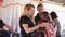 KENYA, KISUMU - MAY 20, 2017: Caucasian women pray for African family, young mother with her son.
