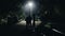 KENYA, KISUMU - MAY 20, 2017: Group of people is standing on the road late at night and talking. African man in hat from