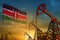 Kenya oil industry concept. Industrial illustration - Kenya flag and oil wells against the blue and yellow sunset sky background