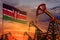 Kenya oil industry concept. Industrial illustration - Kenya flag and oil wells with the red and blue sunset or sunrise sky