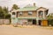 Kenyan architecture house with a small shop and a seller of old