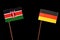 Kenyan flag with German flag isolated on black