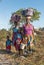 Kenyan Giriama family carrying bundles on head