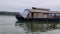 Kerala Backwater with moving traditional House boat full of tourists enjoying the day Kerala tourist destination
