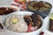 Kerala meals with red rice, sardines curry, sardine fry and coconut based green gram curry