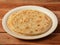 Kerala Paratha, a layered flat bread using wheat flour, popular dish in south India. isolated over a rustic wooden background,