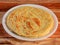 Kerala Paratha, a layered flat bread using wheat flour, popular dish in south India. isolated over a rustic wooden background,