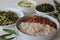 Kerala style veg meals including boiled matta rice, red carrot thoran, beans stir fry, green gram bottle gourd thoran and tempered