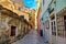 Kerkyra city narrow street view with colorful houses during sunny day. Corfu Island, Ionian Sea, Greece