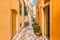 Kerkyra city narrow street view with yellow colorful houses and bikes during sunny day. Corfu Island, Ionian Sea, Greece