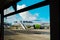 Kerkyra, Greece - 09 29 2022: View From Window of Corfu Airport On Green Plane of AirBaltic. Parking Lot For Aircraft, Aircraft Is