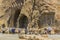 KERMANSHAH, IRAN - JULY 11, 2019: People observe reliefs at Taq-e Bostan in Kermanshah, Ir