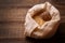 The kernel of cedar nuts in a bag on a wooden background