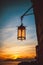 Kerosene lamp on the front of beautiful sunset. Tellaro, Ligurian province, Italy