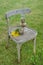 Kerosene lamp, glass beaker and a bouquet of flowers on an old c