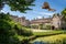 Kestrel hovering over moat in front of Great Chalfield Manor House and moat in Great Chalfield, Wiltshire, UK