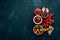 Ketchup sauce in a bowl. Cherry tomatoes, spices, chili peppers, olive oil, parsley. Top view.