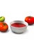 Ketchup sauce in bowl and tomatoes, vertical