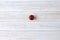 Ketchup in small bawl on wooden background, top view