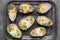 Keto diet dish: Avocado boats with ham cubes, quail eggs, cheese and pepper on metal tray
