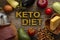 Keto diet low carbs food. Healthy products. Diet concept. Vegetables, fish, meat, nuts, seeds, tomato, apple, cheese on a brown ba