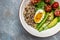 Keto diet plate quinoa, avocado, egg, tomatoes, spinach and sunflower seeds on light background. Healthy food, ketogenic