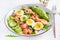 Ketogenic diet breakfast. Salt salmon salad with boiled shrimps, prawns, tomatoes, spinach, eggs and avocado.