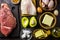 Ketogenic diet food. Balanced low-carb food background. Fish, meat, cheese, nuts on a dark background. Healthy balanced food with