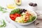 Ketogenic lunch bowl: spiralized courgette with avocado, tomato, feta cheese, olives, bacon