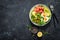 Ketogenic, paleo diet lunch bowl with salted salmon fish, lemon, avocado, olives, boiled egg, cucumber, green lettuce salad