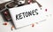ketones abbreviation on the notepad with stethoscope