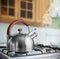 Kettle boiling on a gas stove in the kitchen