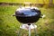 Kettle Charcoal BBQ Barbecue Grill in garden or backyard.