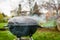 Kettle Charcoal BBQ Barbecue Grill in garden or backyard