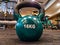 Kettlebell as round ball shaped dumbbell of 16 kilograms placed on the gym floor interior for weight loss and bodybuilding for a