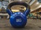 Kettlebell as round ball shaped dumbbell of 8 kilograms placed on the gym floor interior for weight loss and bodybuilding for a