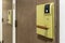 Key card door opener on brown wood door