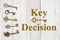 Key Decision text with skeleton keys on weathered whitewash wood