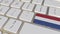 Key with flag of the Netherlands on the computer keyboard switches to key with flag of Great Britain, translation or