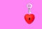 Key and heart shape with keyhole on pink