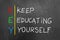 Key keep education yourself text on blackboard