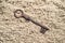 Key lost in sand.