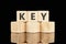 KEY text assembled from wooden cubes on a black background