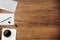 Keyboard and cup of coffee on wooden table in