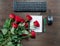 Keyboard office supplies and fresh red roses