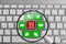 Keyboard with red and green online shopping theme buttons and magnifying glass