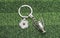 Keychain with a soccer ball shape on green